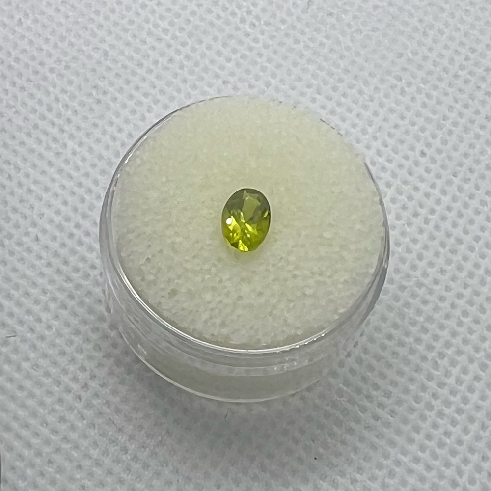 HOLD 6.8 mm Peridot Loose Gemstone Oval Cut size is between 3/4 and 1 carat